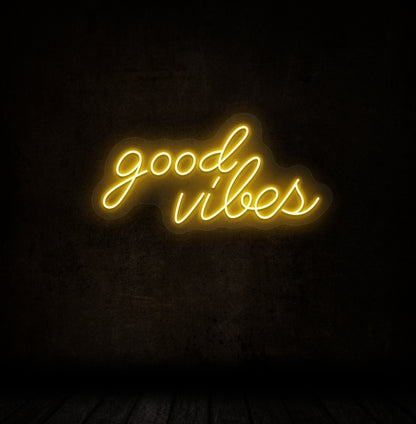 A stylish orange LED "good vibes" neon sign mounted on a dark wall. Perfect for bedrooms, gaming, streaming setups, and cafés.