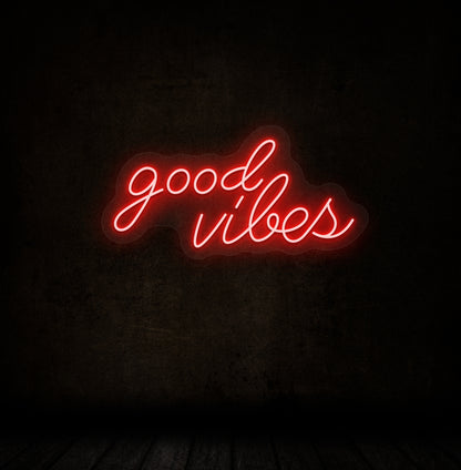 A stylish red LED "good vibes" neon sign mounted on a dark wall. Perfect for bedrooms, gaming, streaming setups, and cafés.