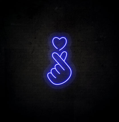 Image of a hand heart LED neon sign mounted on dark wall in blue color.