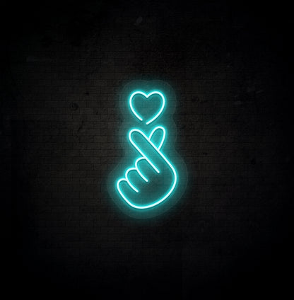 Image of a hand heart LED neon sign mounted on dark wall in ice blue color.