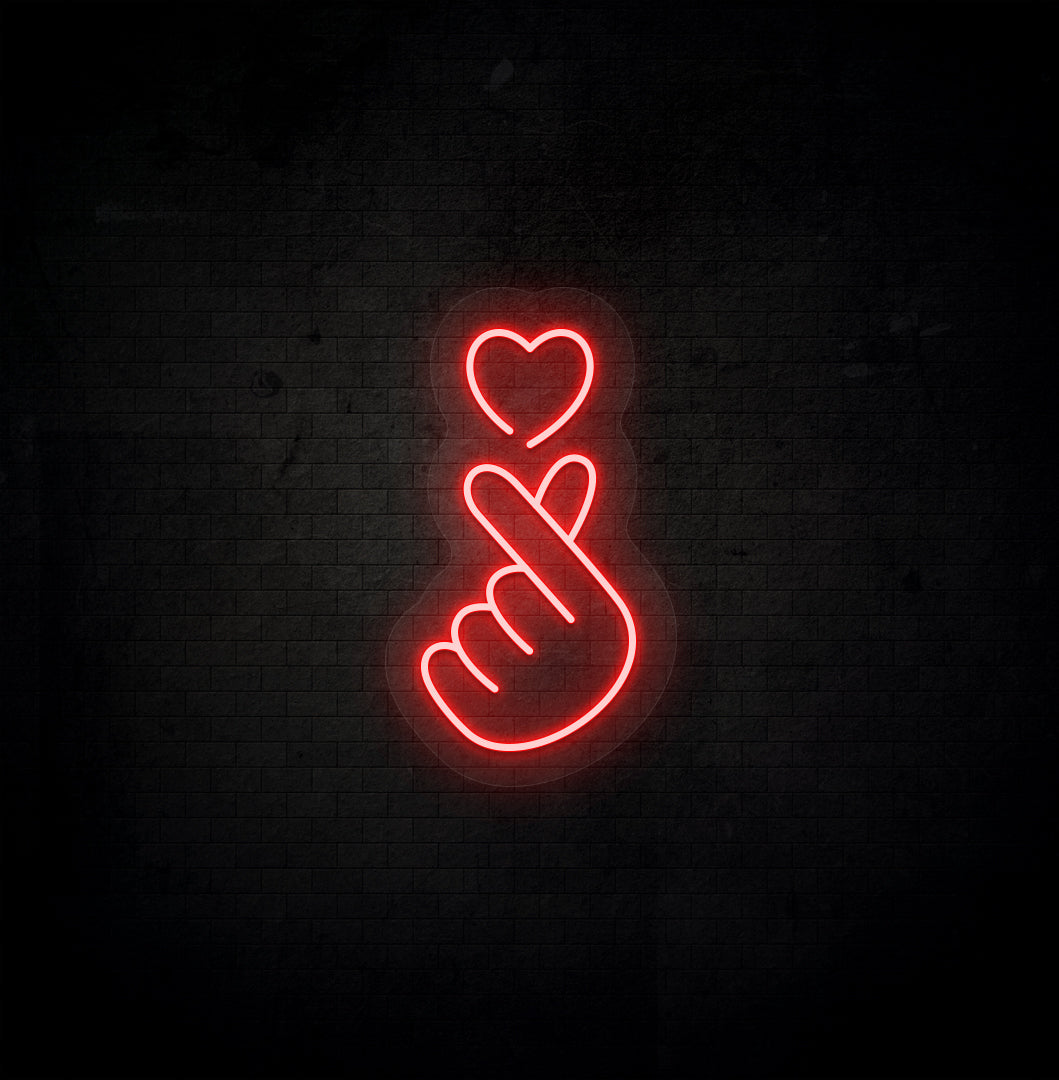 Image of a hand heart LED neon sign mounted on dark wall in red color.