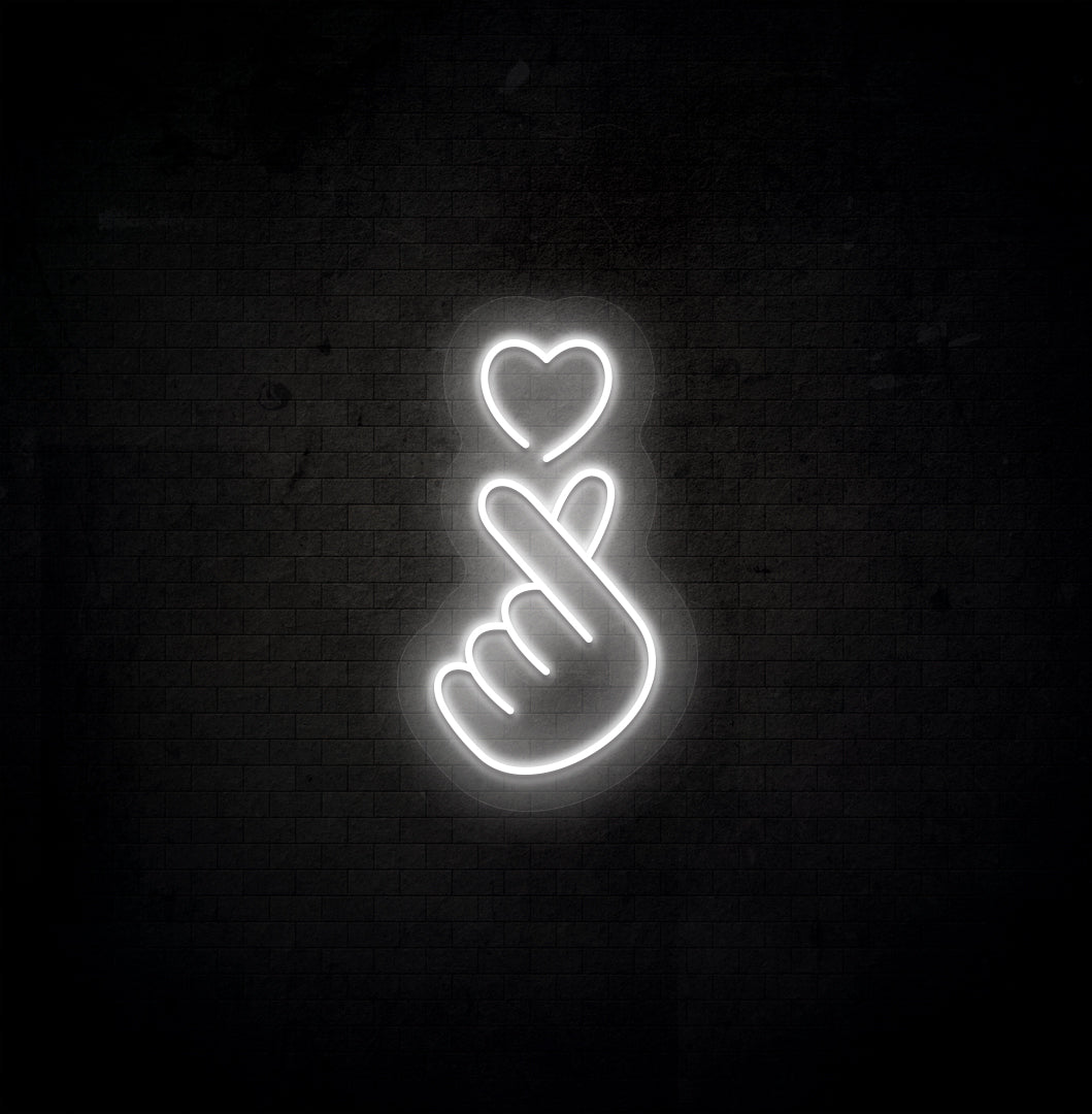 Image of a hand heart LED neon sign mounted on dark wall in white color.
