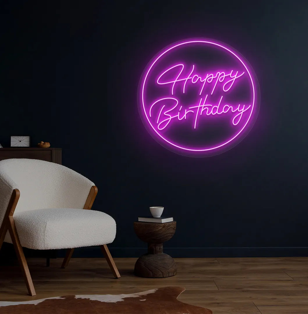 Happy Birthday in circle LED neon sign glowing pink for celebration backdrop.