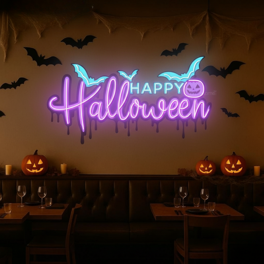 Image of a happy Halloween neon sign with bats glowing on a wall in pink.