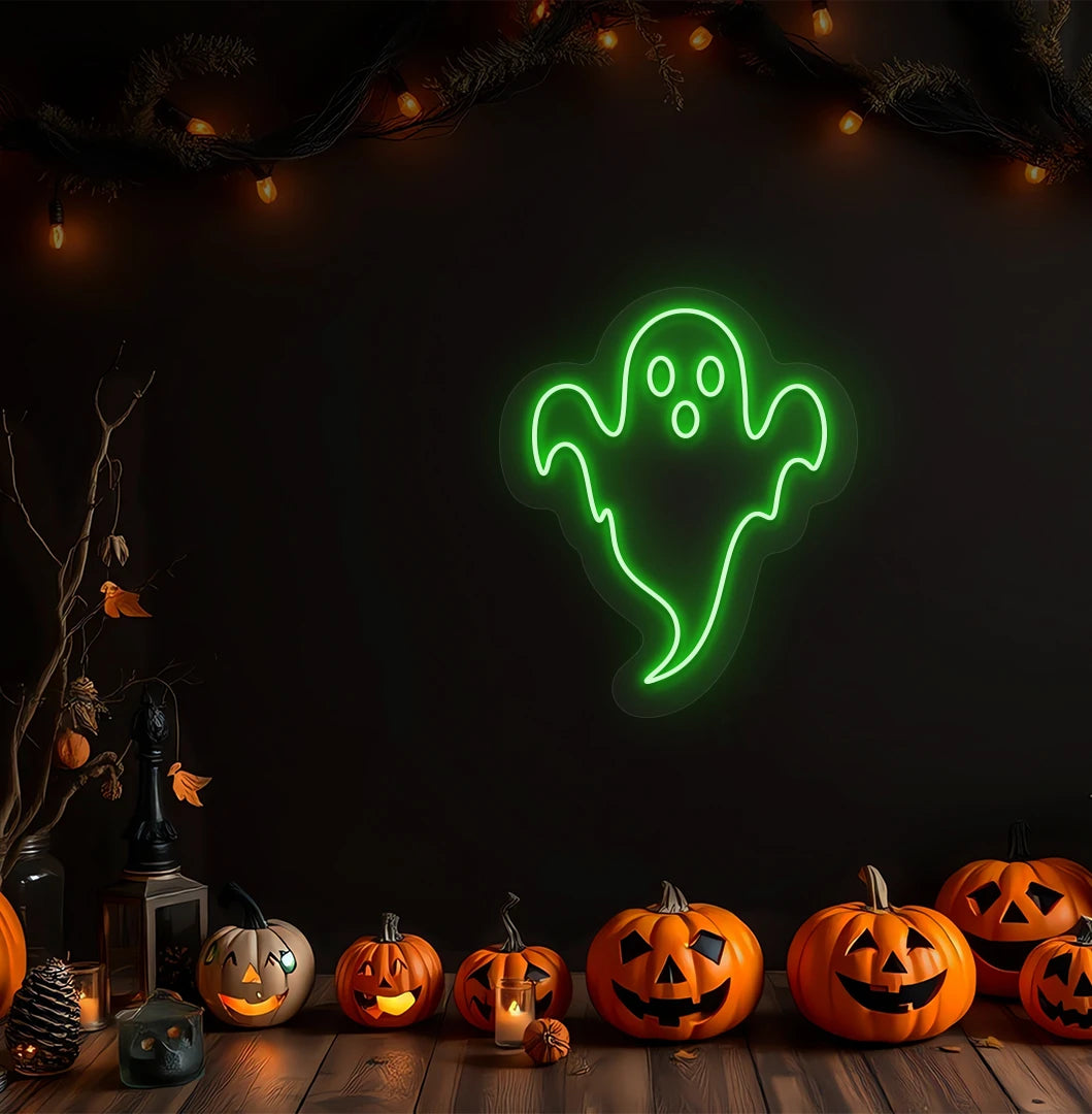 Modern Halloween wall with haunted ghost neon sign glowing green above pumpkins.