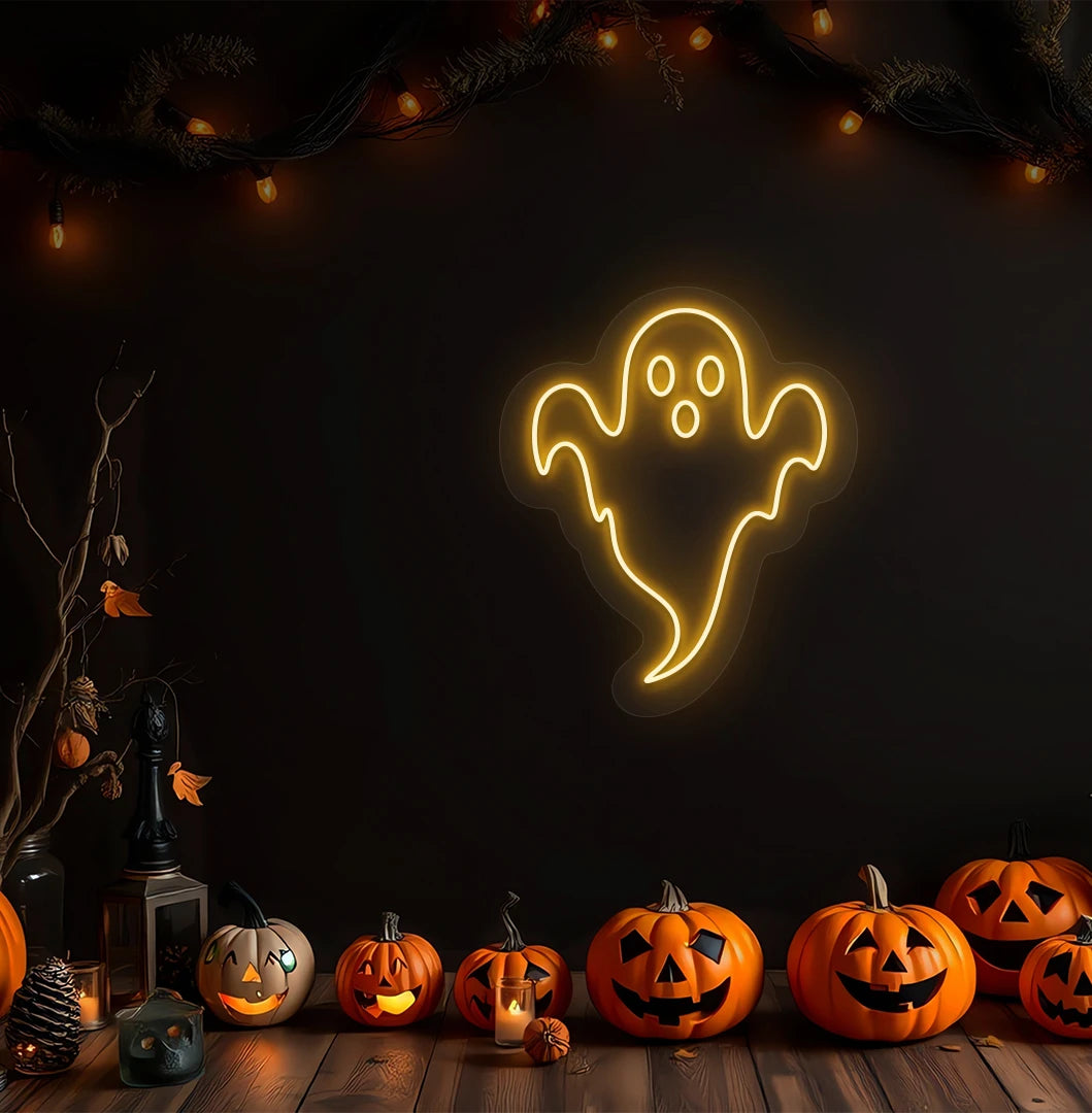 Modern Halloween wall with haunted ghost neon sign glowing orange above pumpkins.
