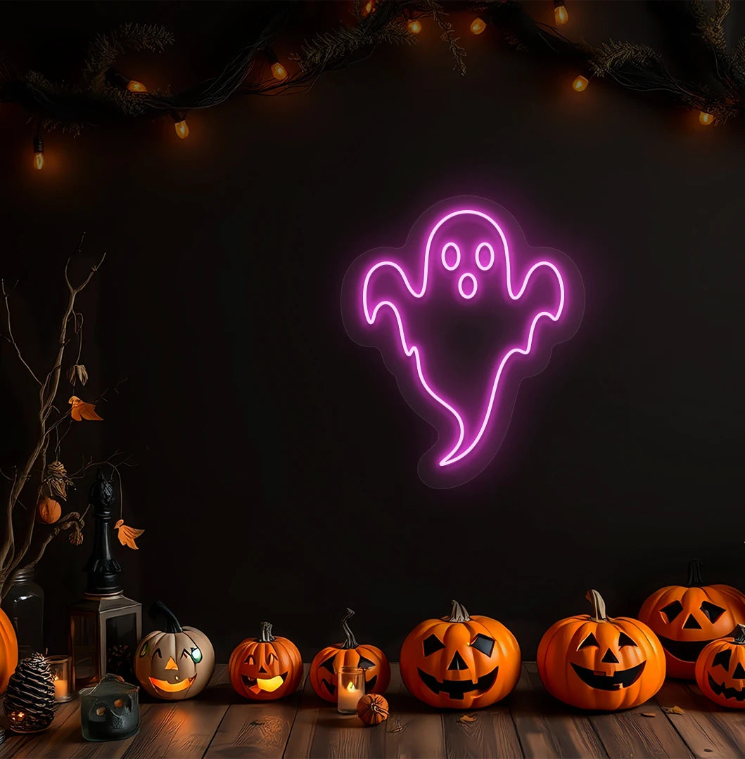 Image of a haunted ghost neon sign above pumpkins on Halloween wall in pink color.