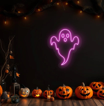 Image of a haunted ghost neon sign above pumpkins on Halloween wall in pink color.
