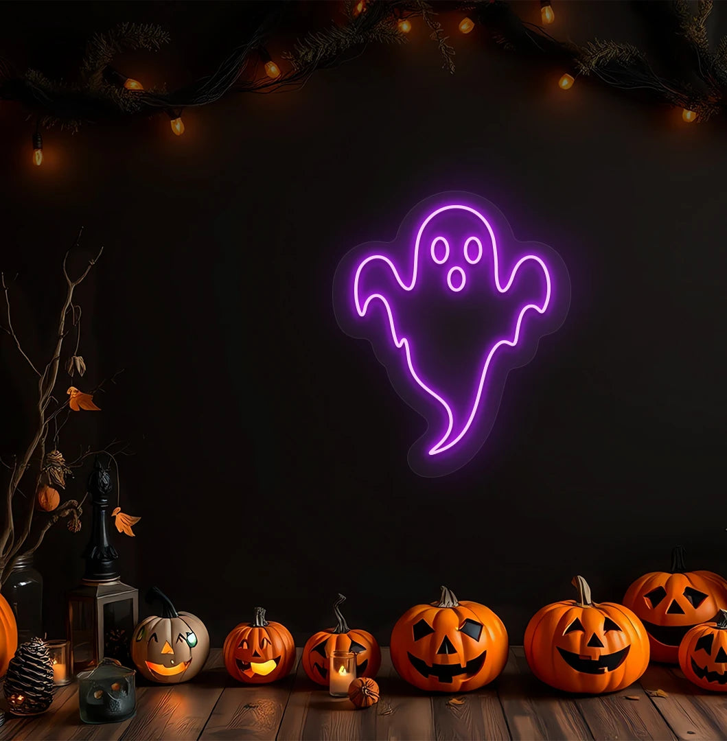 Modern Halloween wall with haunted ghost neon sign glowing purple above pumpkins.