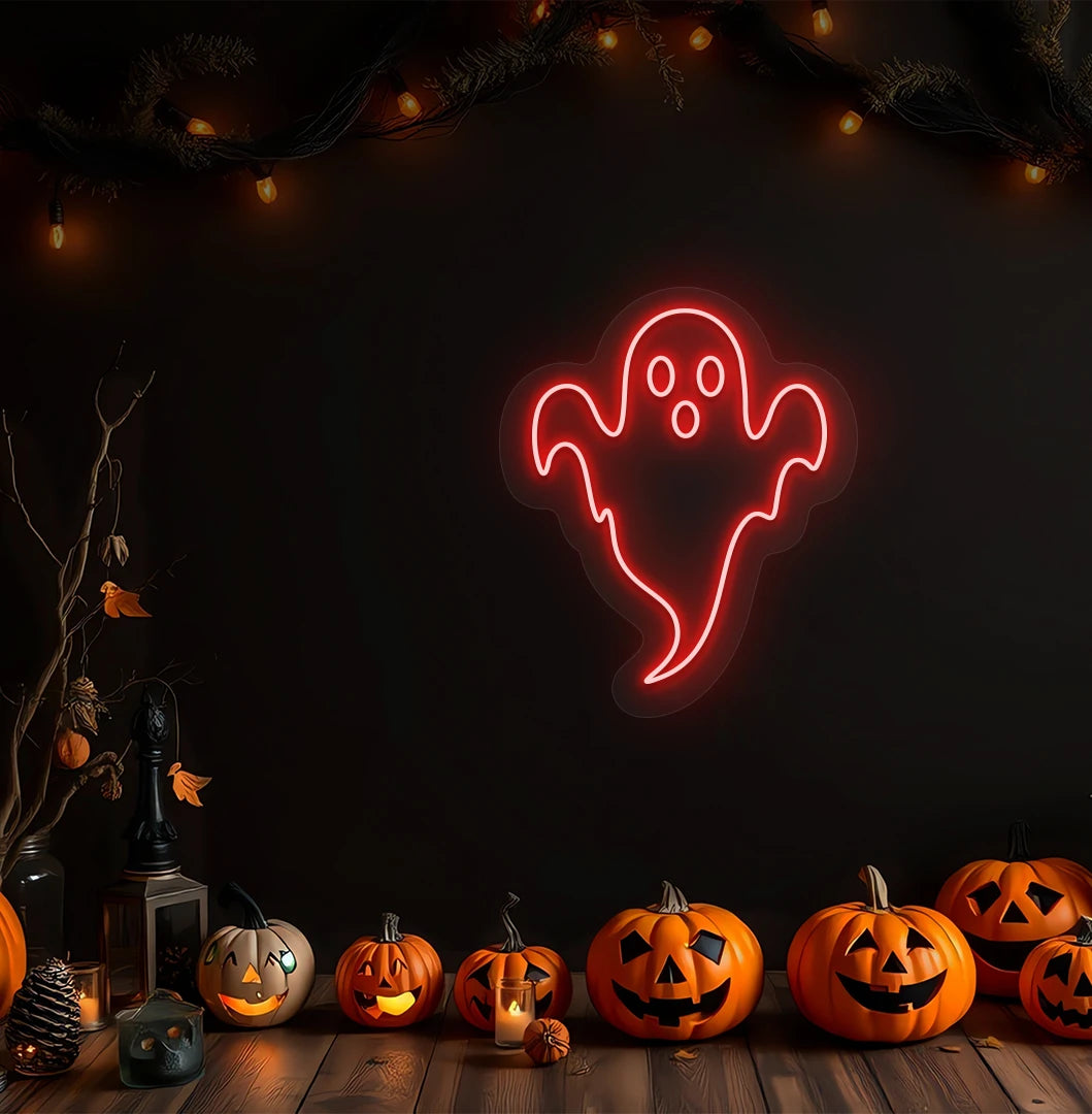 Image of a haunted ghost neon sign above pumpkins on Halloween wall in red color.