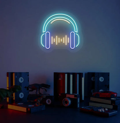 Image of a headphone neon sign in ice blue color mounted on room wall.