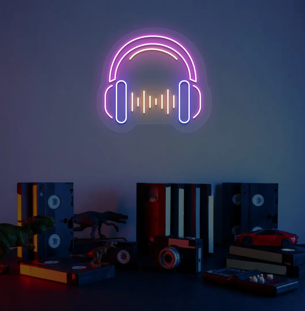 Image of a headphone neon sign in pink color mounted on room wall.