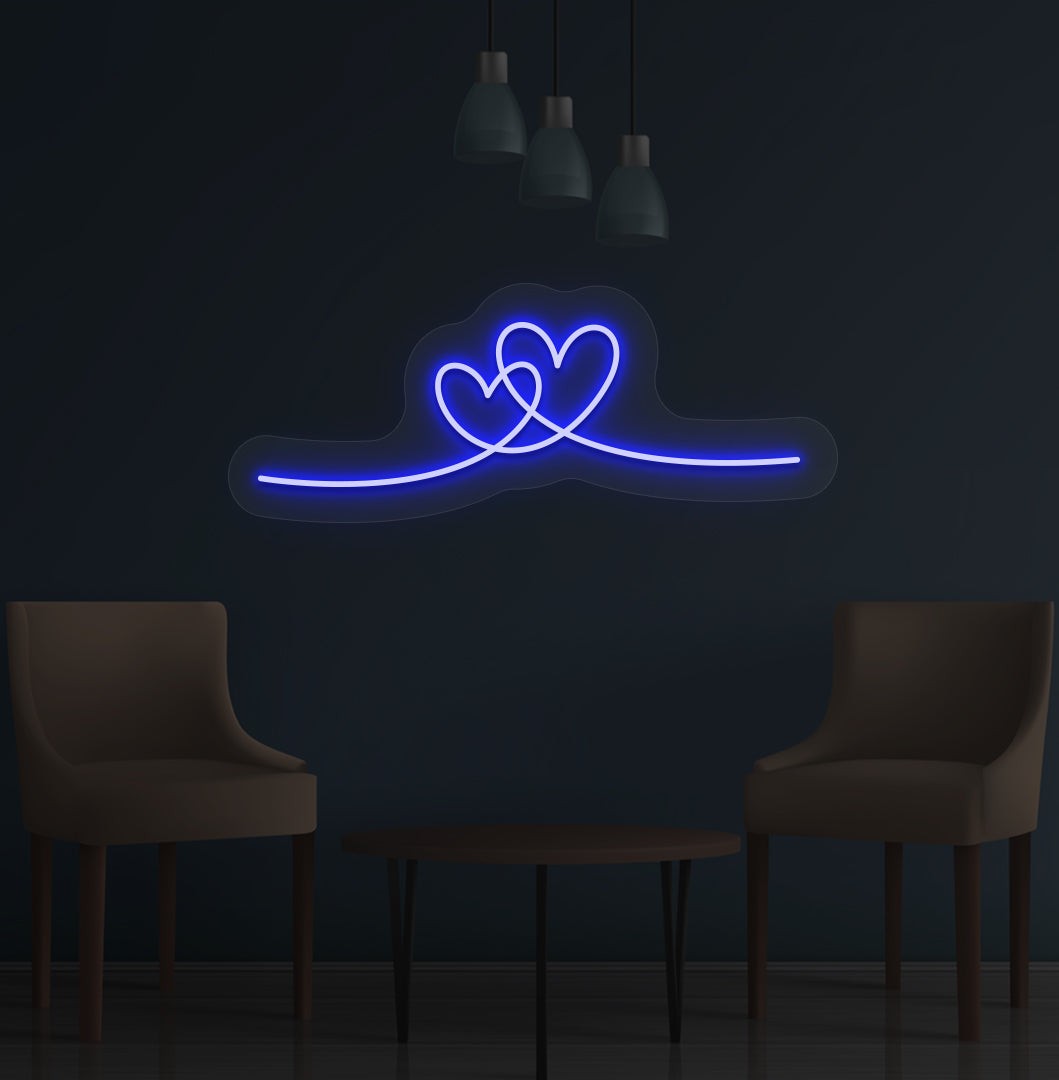Image of a romantic heart LED neon sign glowing on a wall in blue color.