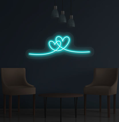 Image of a romantic heart LED neon sign glowing on a wall in ice blue color.