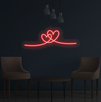 Image of a romantic heart LED neon sign glowing on a wall in red color.