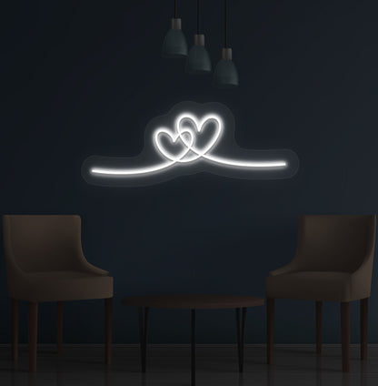Image of a romantic heart LED neon sign glowing on a wall in white color.