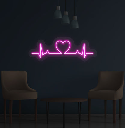 Image of a heartbeat LED neon sign glowing on a wall in pink color.