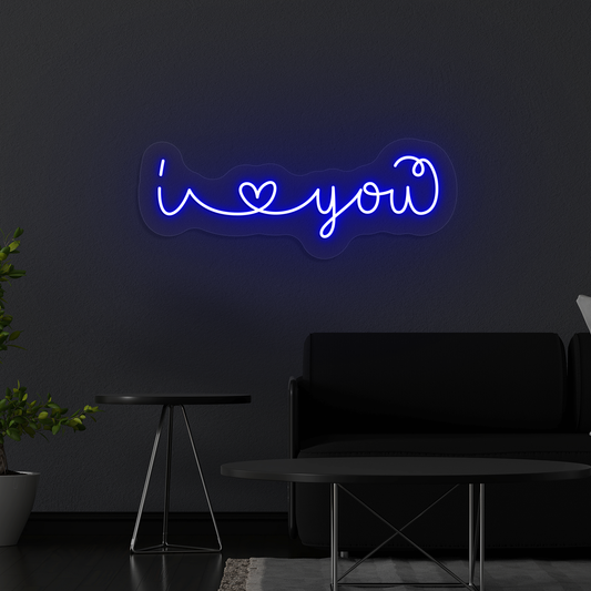 Image of a Romantic "I love you" neon sign glowing on a wall in blue color.