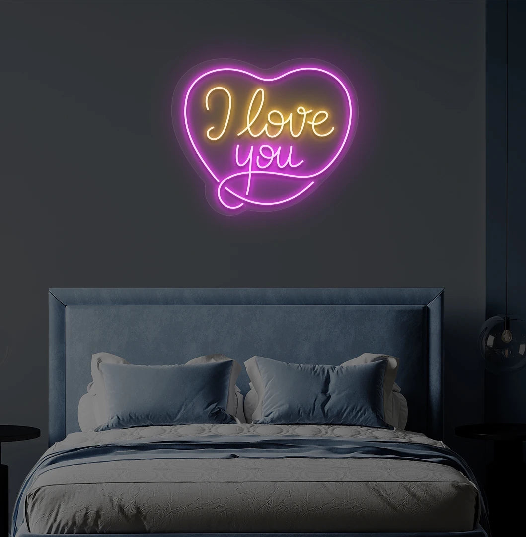 Romantic I love you heart neon sign in orange mounted on bedroom wall.