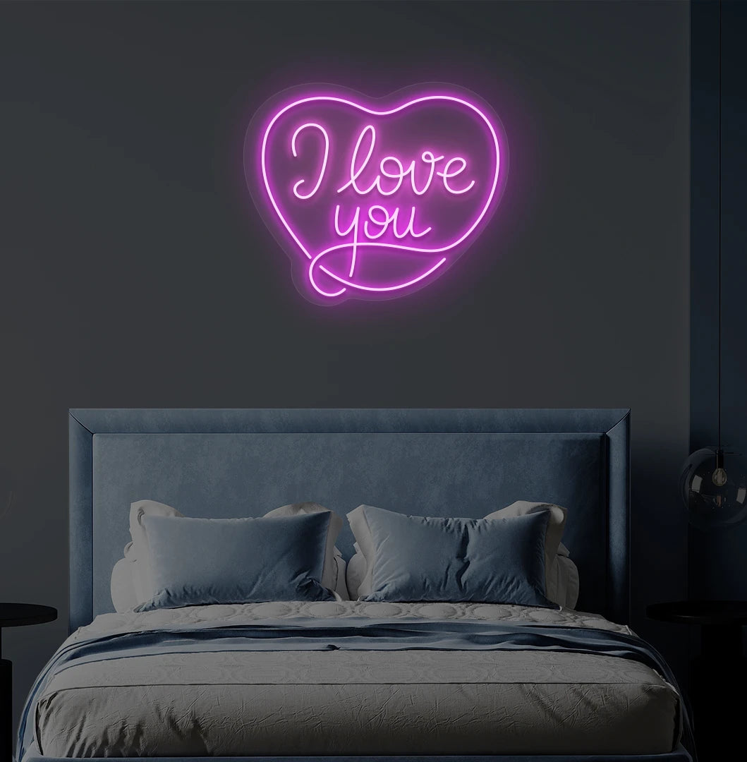 Modern bedroom wall with I love you neon sign in heart shape glowing pink.