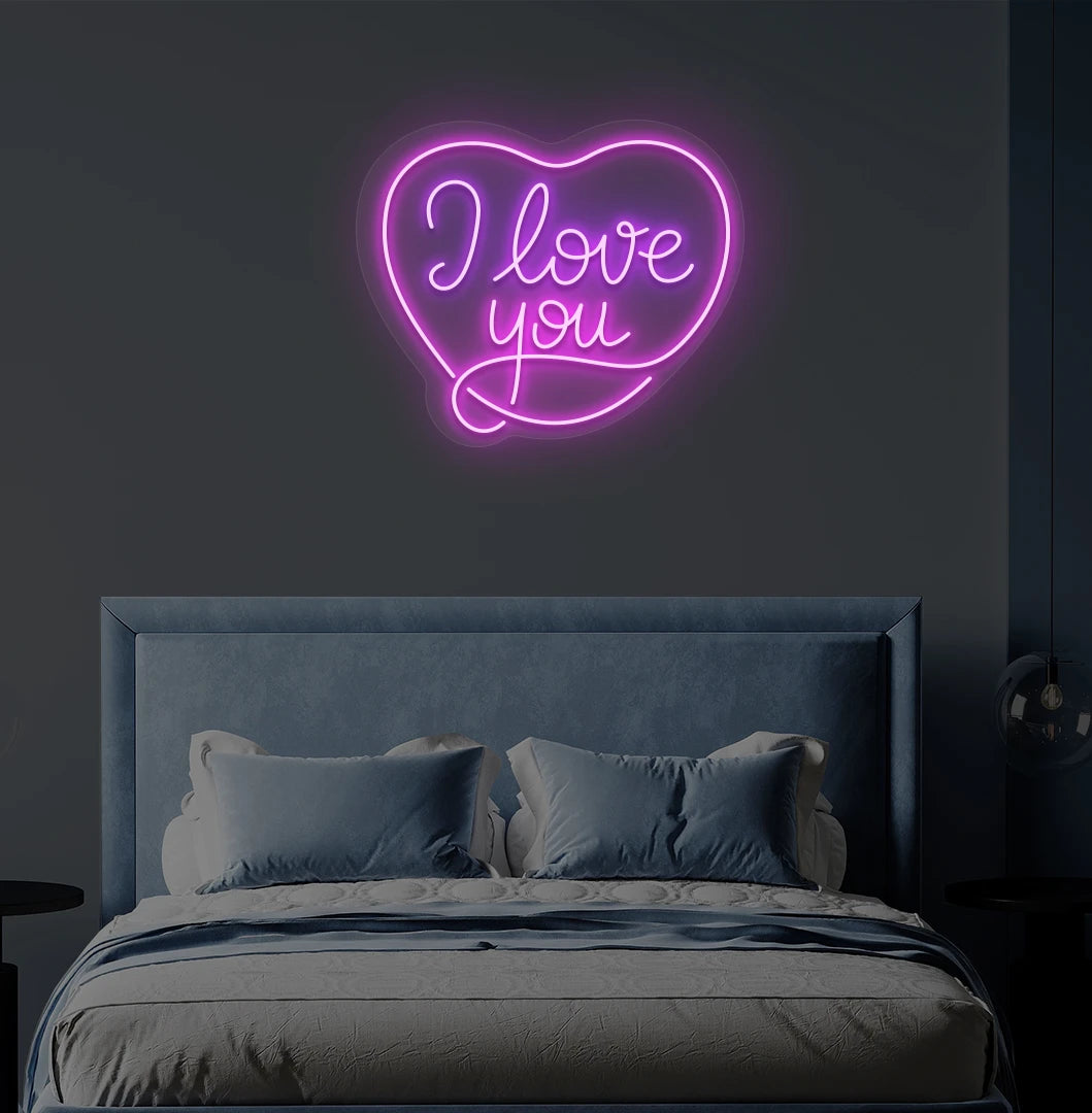 Romantic I love you heart neon sign in purple mounted on bedroom wall.