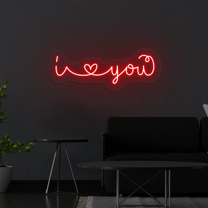 Image of a Romantic "I love you" neon sign glowing on a wall in red color.