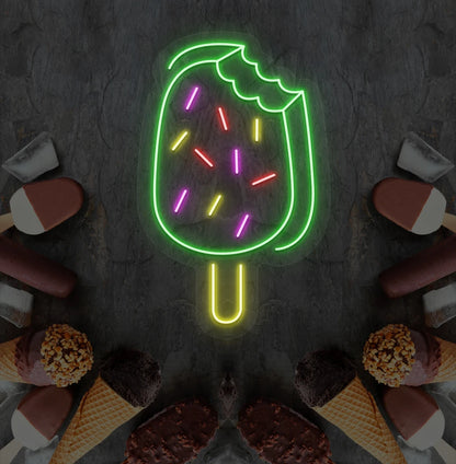 Fun ice cream bar neon sign in green mounted on dessert theme wall.