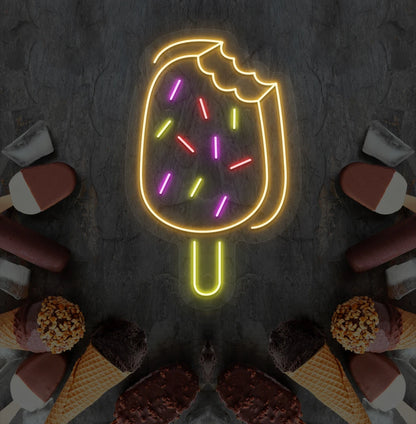 Fun ice cream bar neon sign in orange mounted on dessert theme wall.