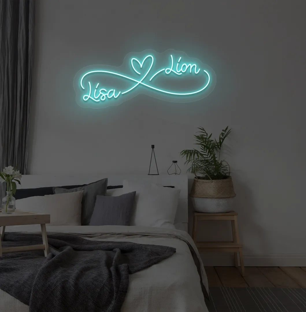 Custom Infinity Couple Name ice blue LED neon sign mounted on bedroom wall.