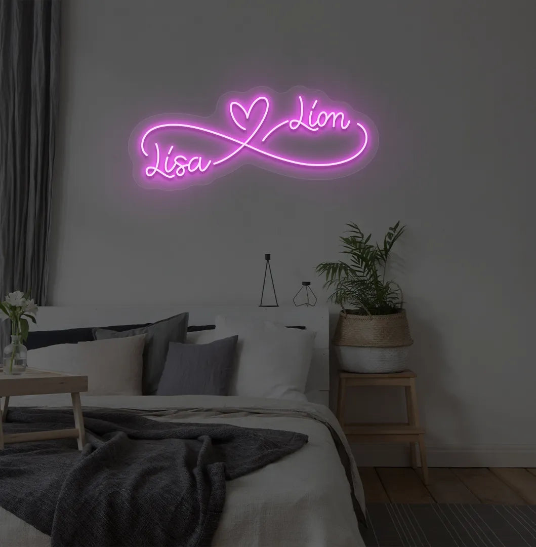 Custom Infinity Couple Name pink LED neon sign mounted on bedroom wall.