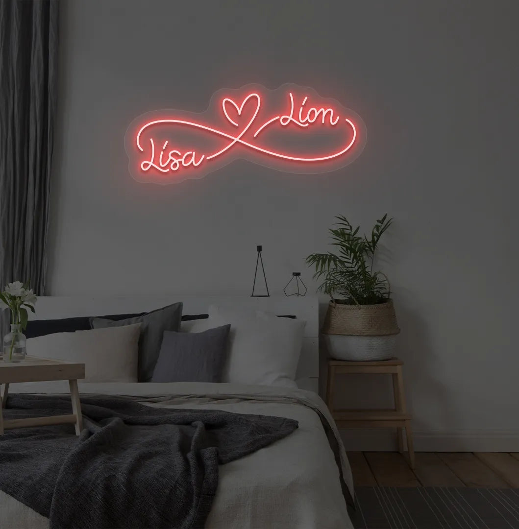 Custom Infinity Couple Name red LED neon sign mounted on bedroom wall.