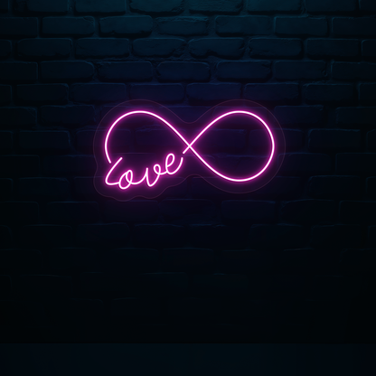 Image of a romantic "infinity love" LED neon sign glowing on wall in pink color.