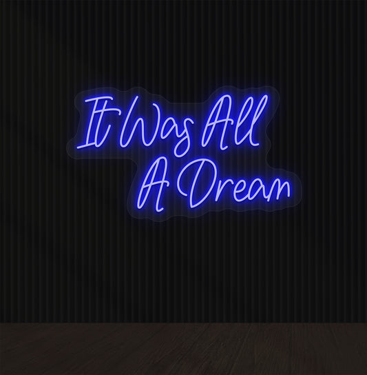 Image of an "it was all a dream" LED neon sign glowing on a dark wall in blue color.