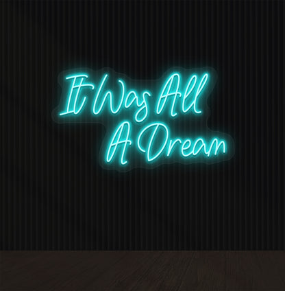 Image of an "it was all a dream" LED neon sign glowing on a dark wall in ice blue color.