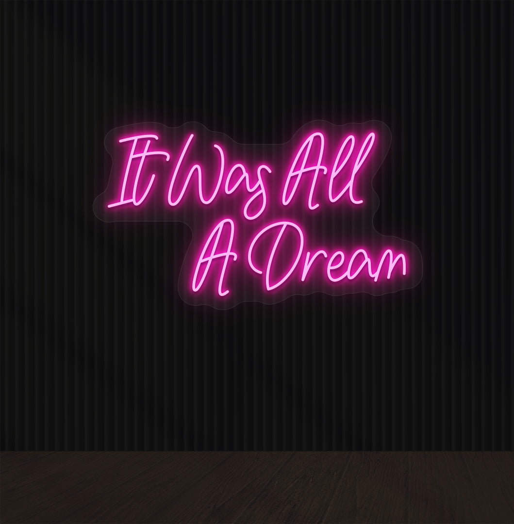 Image of an "it was all a dream" LED neon sign glowing on a dark wall in pink color.