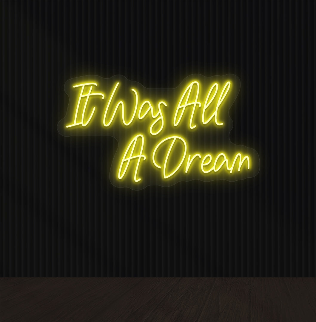 Stylish yellow LED "It was all a dream" neon sign mounted on dark wall. Perfect for bedrooms, gaming, creative studios, and aesthetic interiors.