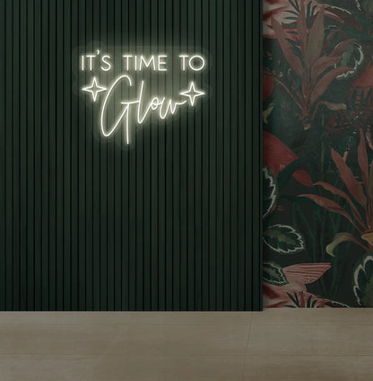 Modern salon aesthetic wall with it’s time to glow neon sign glowing warm white.