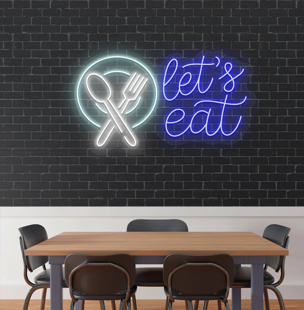 Image of a let’s eat neon sign with plate and cutlery icon glowing on cafe wall in blue color.