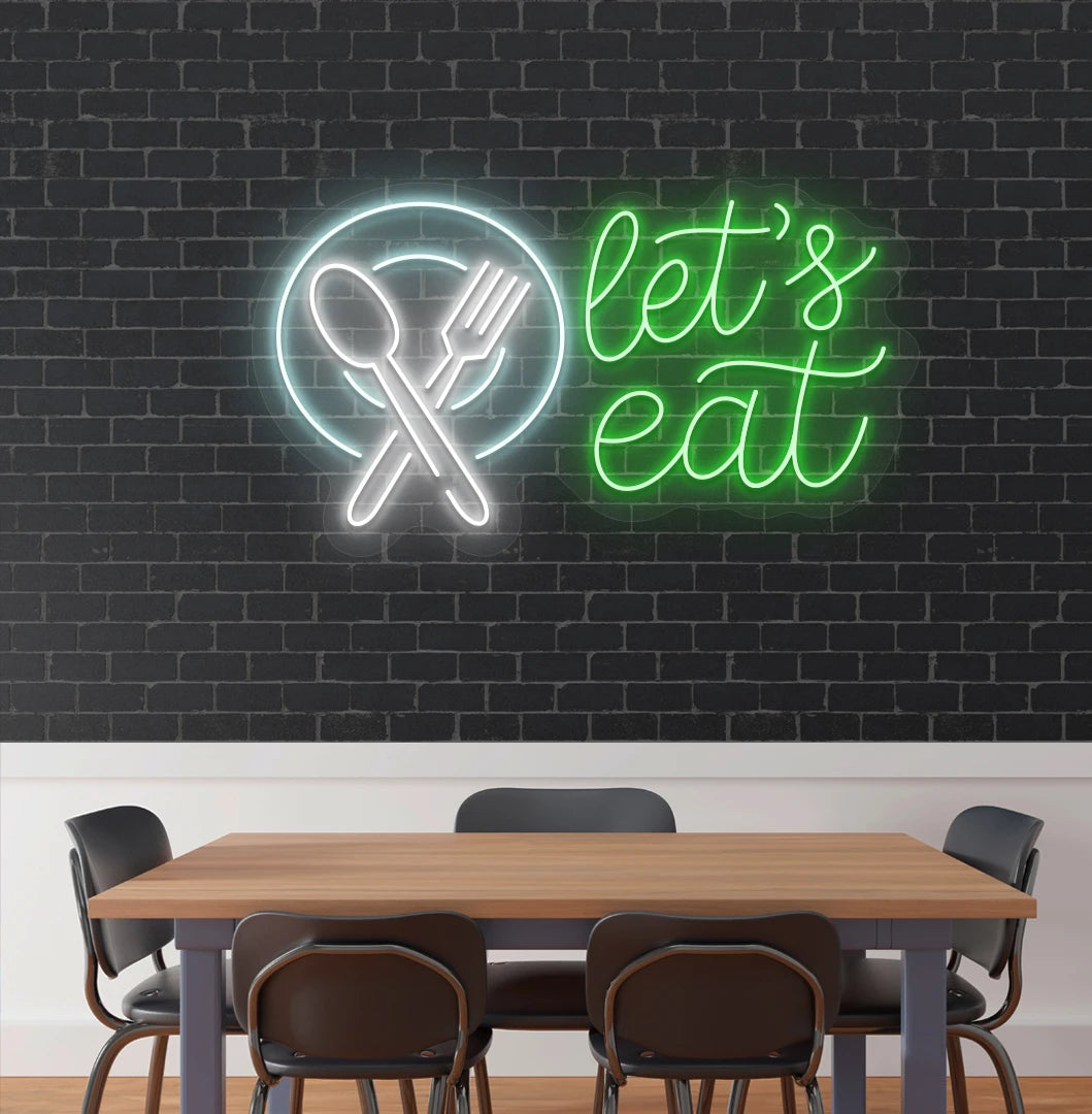 Let’s eat neon sign with a plate and crossed cutlery icon in green cafe interior.