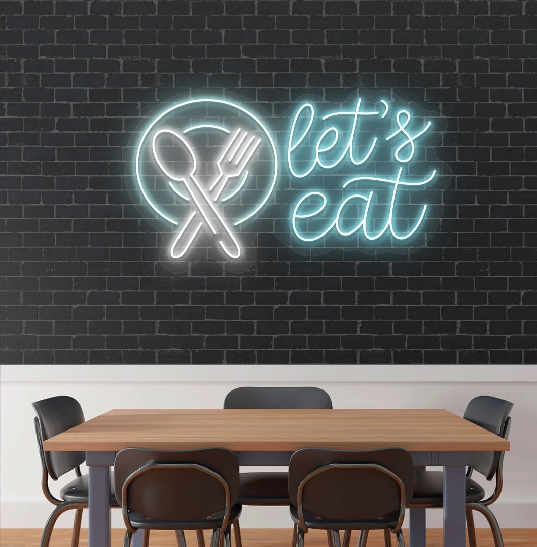 Image of a let’s eat neon sign with plate and cutlery icon glowing on cafe wall in ice blue color.