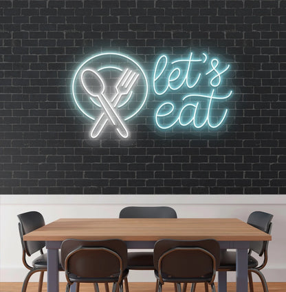 Image of a let’s eat neon sign with plate and cutlery icon glowing on cafe wall in ice blue color.