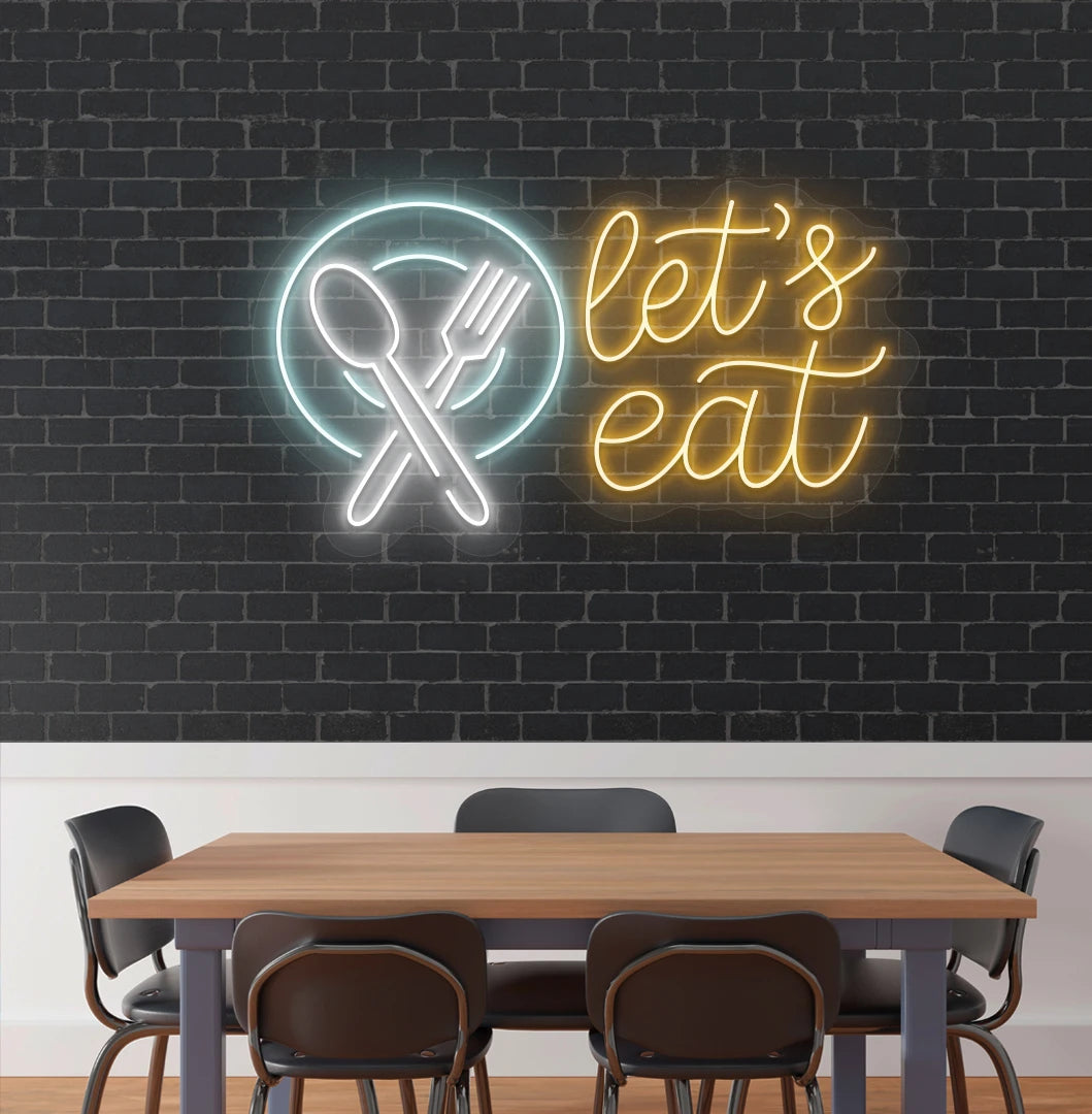 Let’s eat neon sign with a plate and crossed cutlery icon in orange cafe interior.