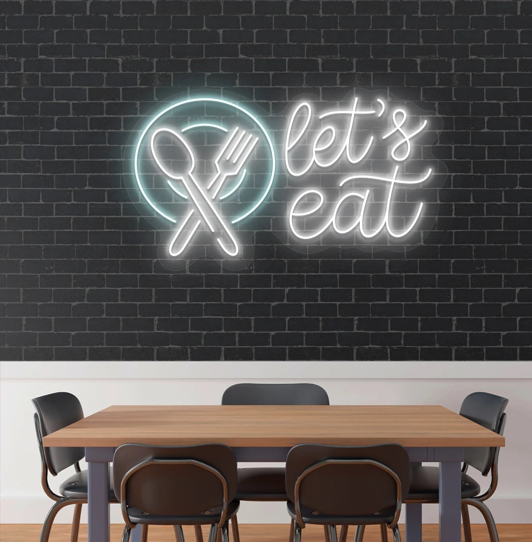 Image of a let’s eat neon sign with plate and cutlery icon glowing on cafe wall in white color.