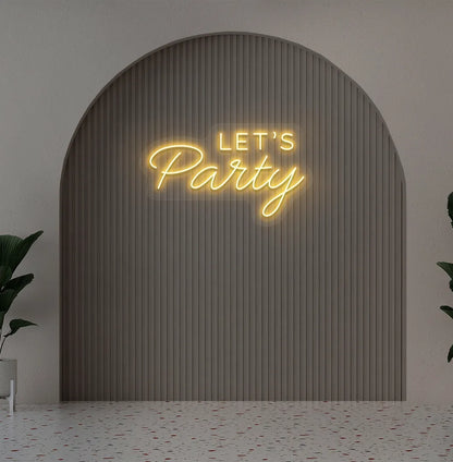 Image of a festive Let's Party orange neon sign glowing on decorative wall.