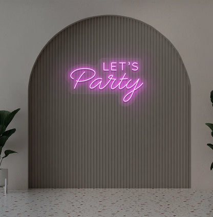 Party-themed Let's Party neon sign mounted on modern event wall in pink color.