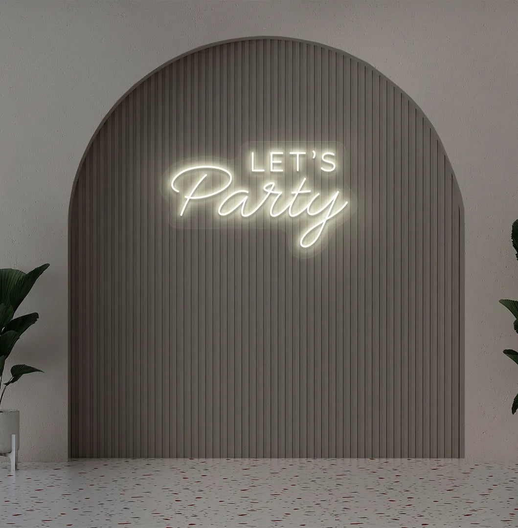 Image of a festive Let's Party warm white neon sign glowing on decorative wall.
