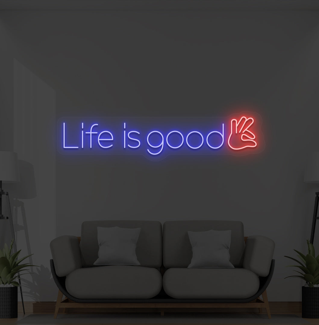 Image of a positive "life is good" LED neon sign glowing blue on wall.
