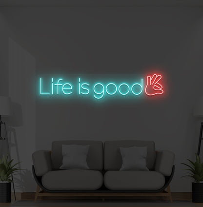 Image of a positive "life is good" LED neon sign glowing ice blue on wall.