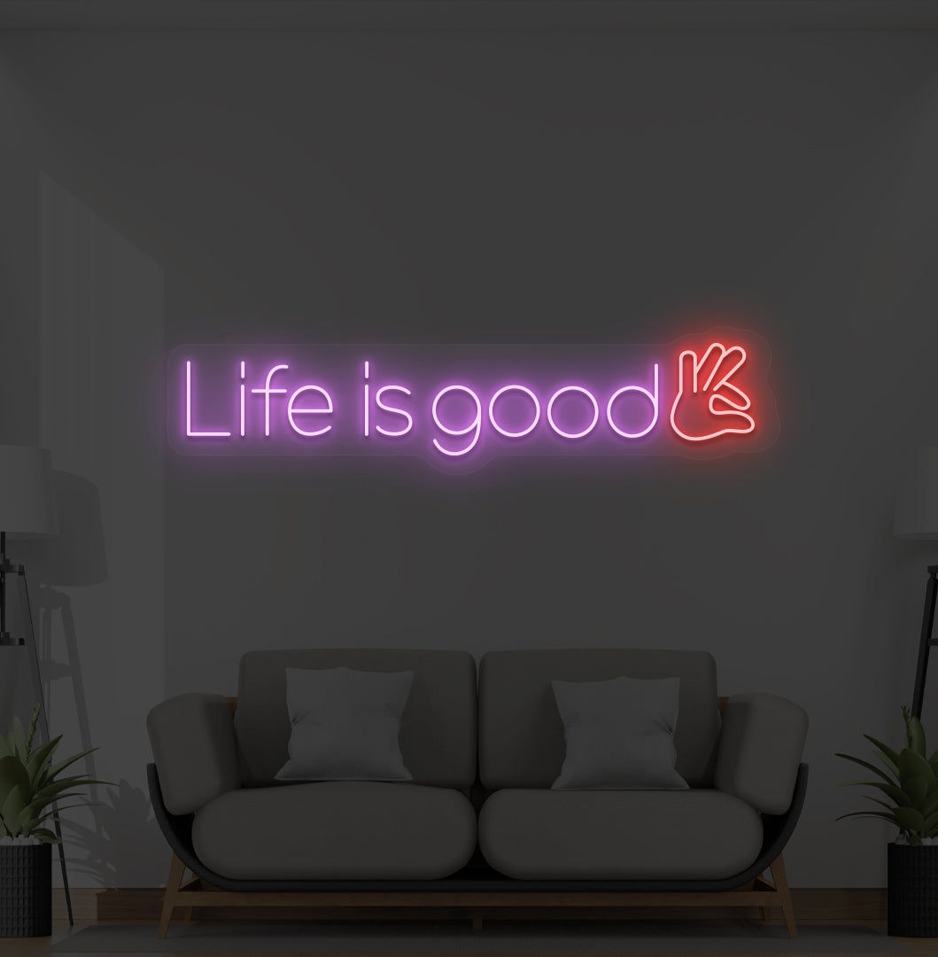 Aesthetic wall with "life is good" neon sign glowing purple.