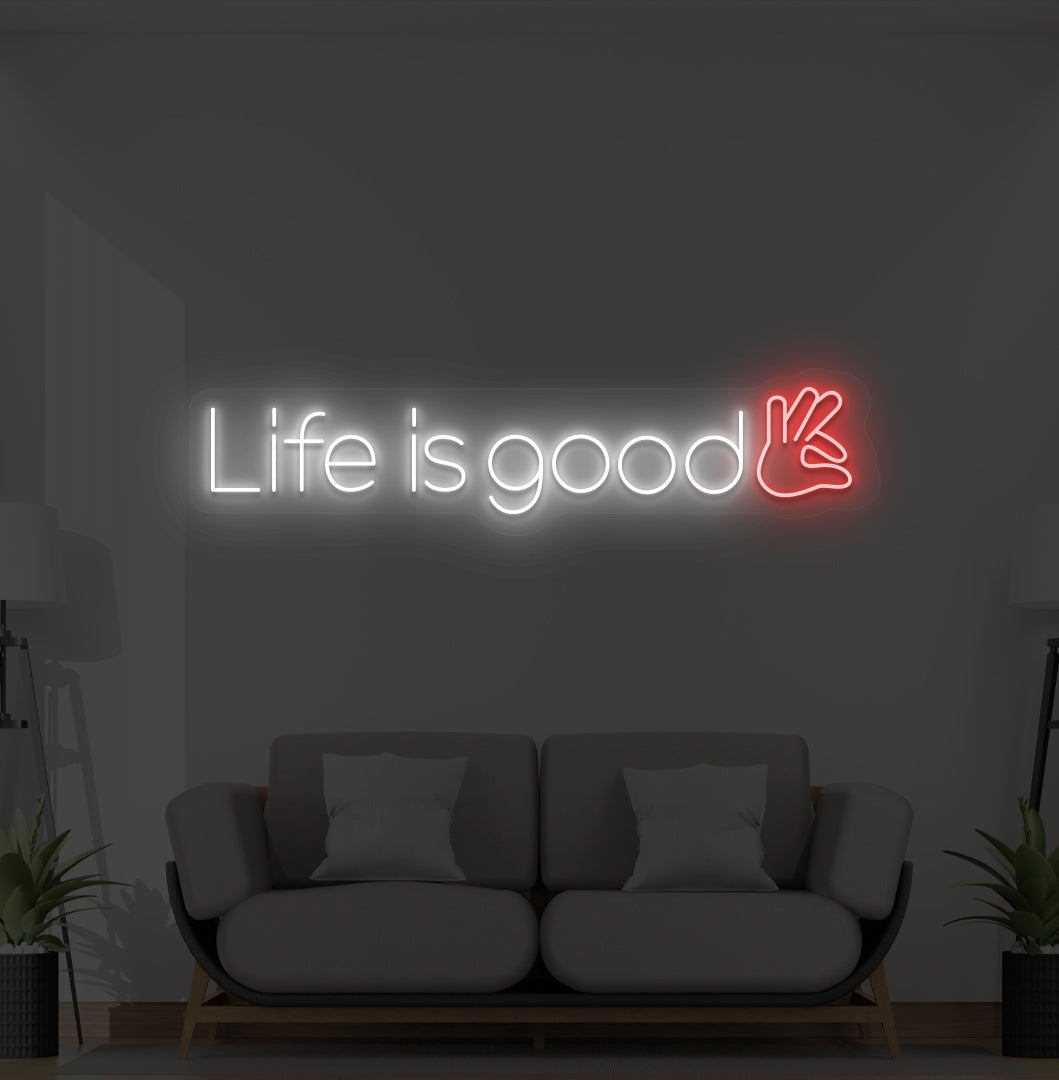 Image of a positive "life is good" LED neon sign glowing white on wall.